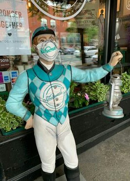 "Greeter" jockey at Silverwood Gallery on Broadway in Saratoga Springs sports his mask to remind customers to do the same.